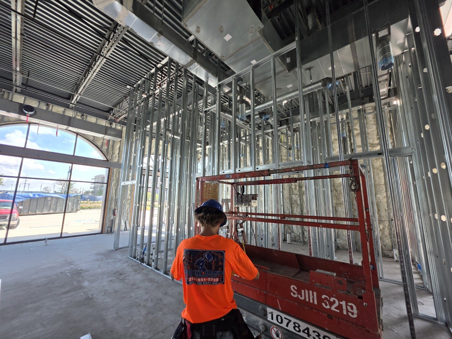 Right Hand Construction team member in a company shirt on a commercial job site