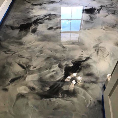 Gray and white metallic epoxy floor with a high-gloss finish in a residential room