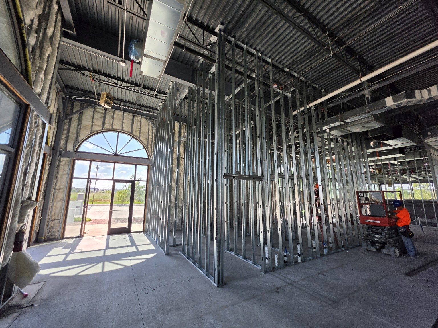 Metal stud framing and storefront glazing inside a commercial shell