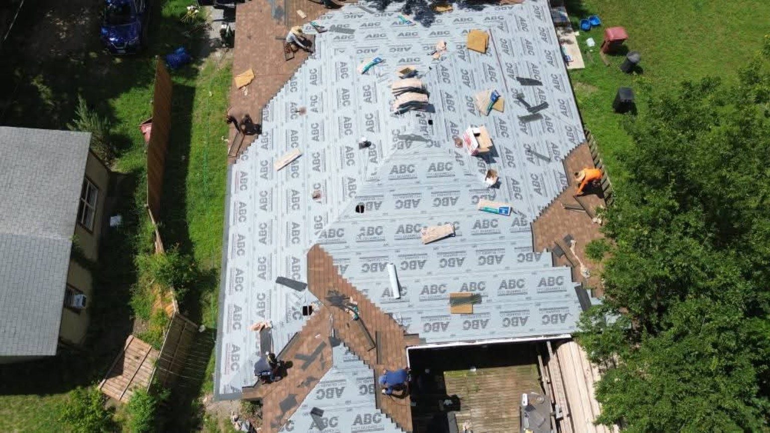 Aerial view of a roof with new synthetic underlayment installed