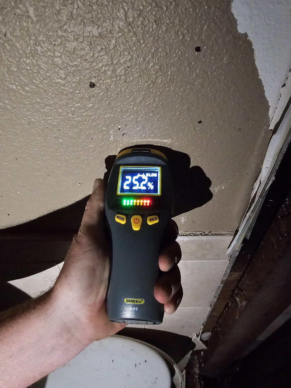 Moisture meter reading taken on a damaged interior wall