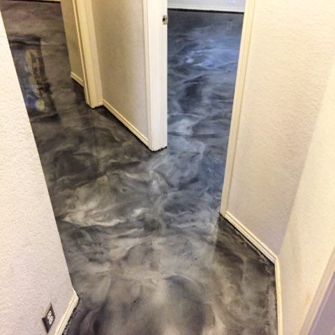 Charcoal metallic epoxy floor running through a hallway and doorway