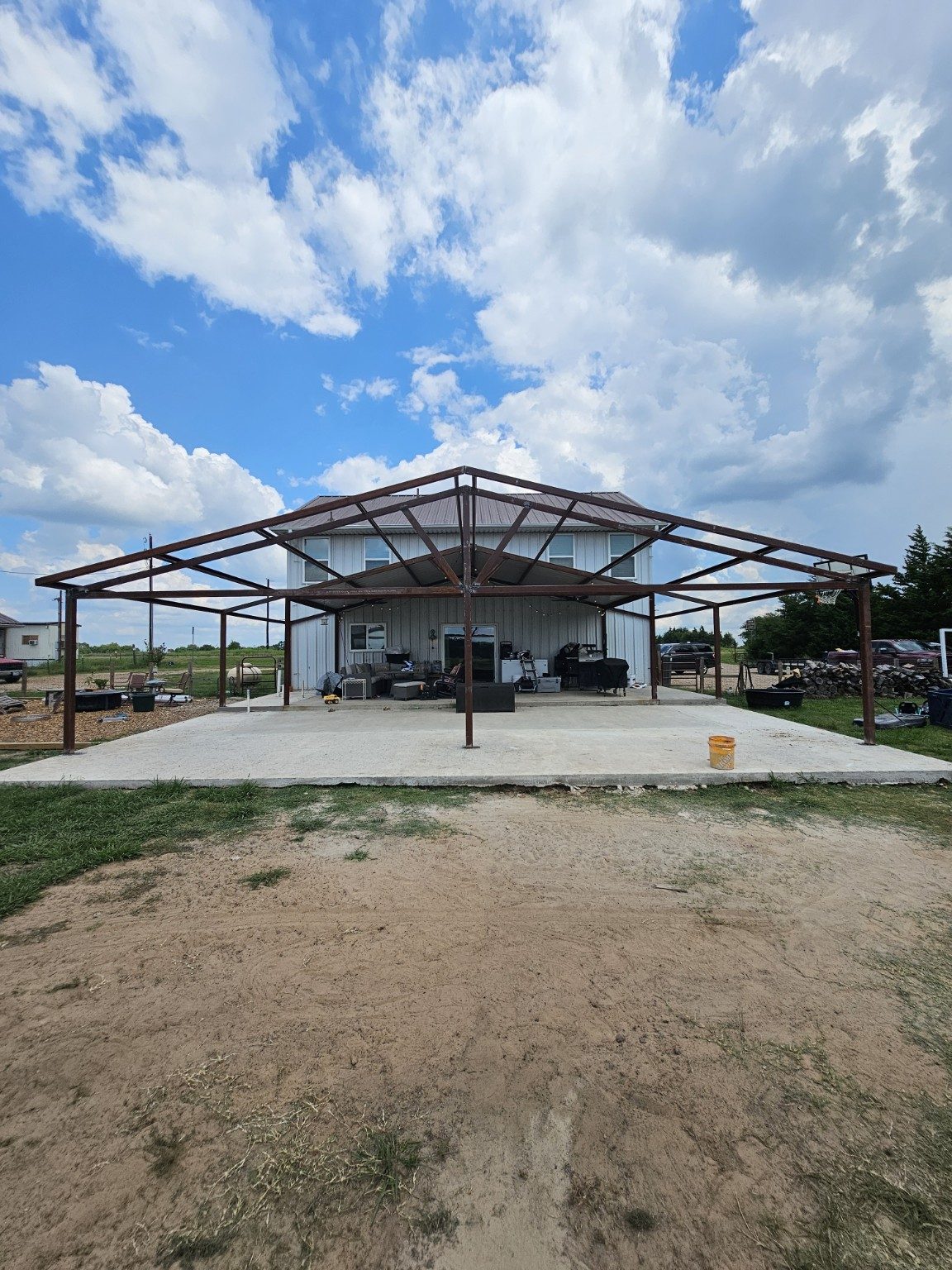 Steel pavilion frame set over a new concrete slab